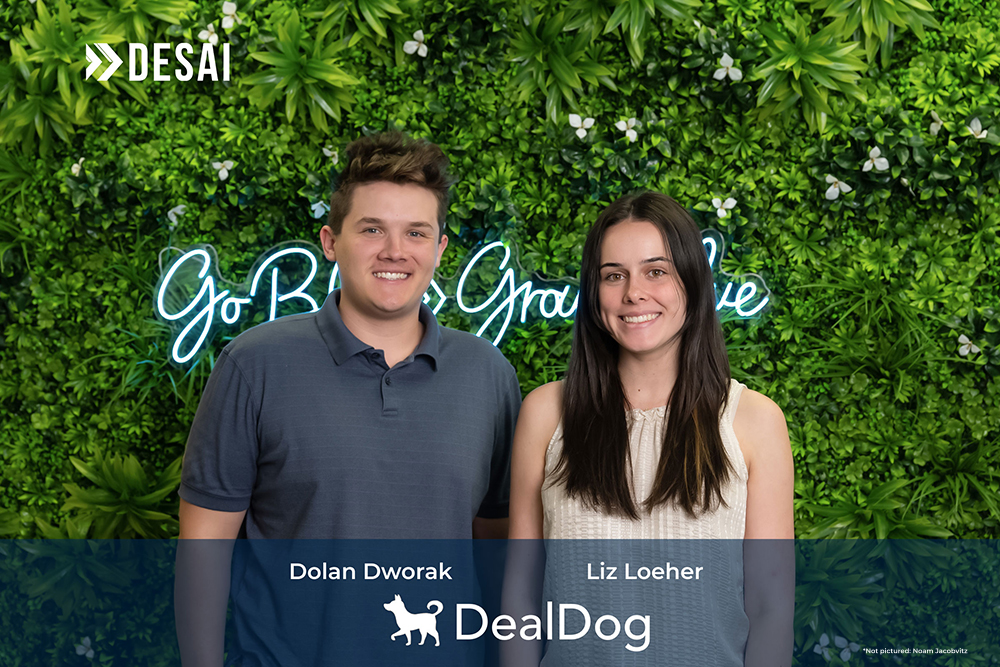 DealDog founders standing against a wall of greenery
