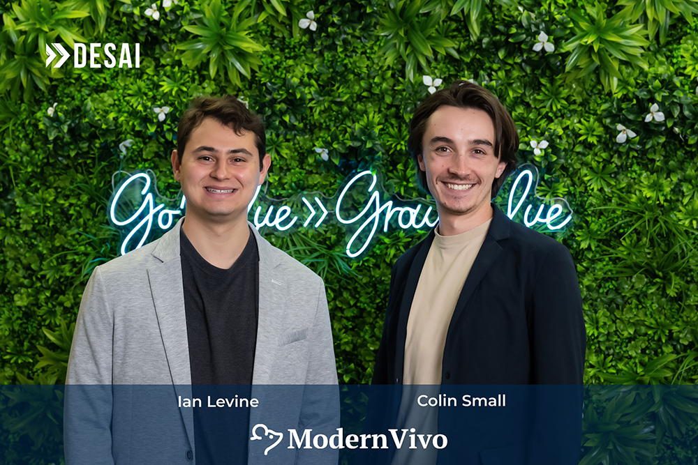 ModernVivo founders standing against a wall of greenery.